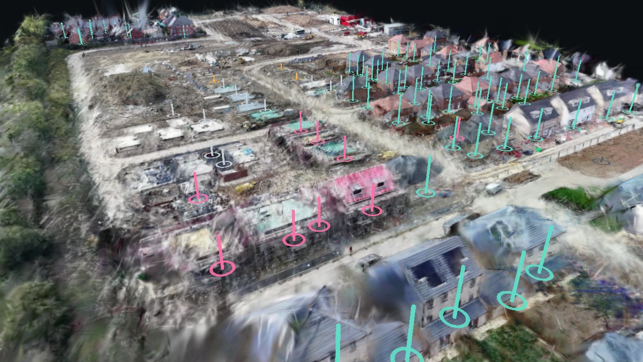A housing site rebuilt in 3D with coloured pins on plots at different build stages