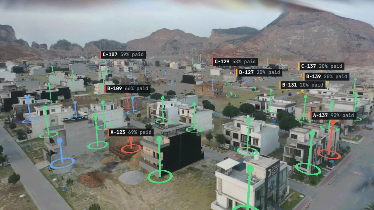 A 3D housing society with every plot coloured by payment status